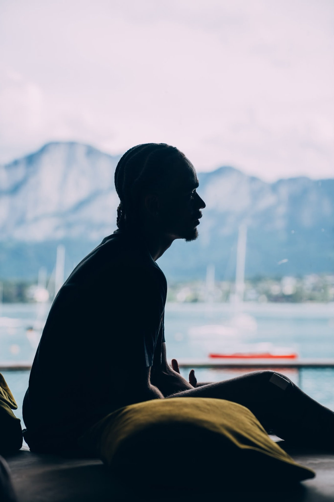 Silhouette of Xavi Simons by a lake in the mountains